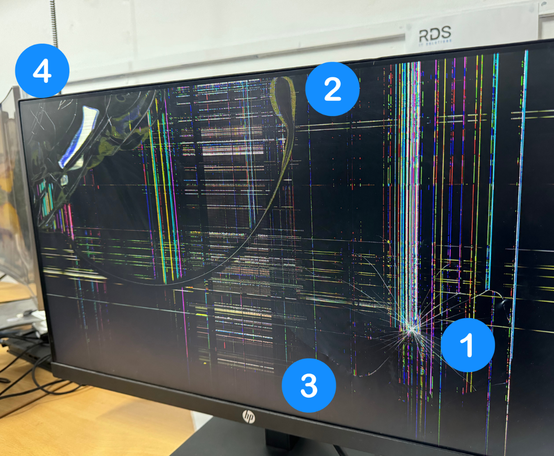 Damaged laptop screen showing cracks, black spots, lines, and display distortion needing repair